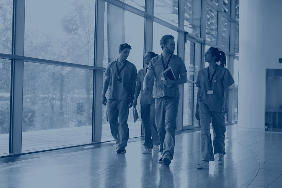 four-healthcare-workers-in-scrubs-walking-in-corri-2023-11-27-05-28-57-utc_edited.jpg